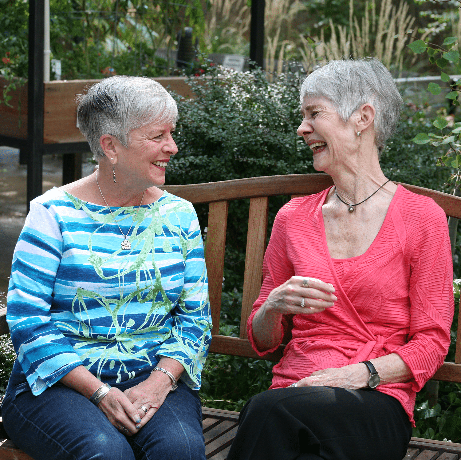 Two residents on a bench sitting; serves as a link to the Life Enrichment Program page!